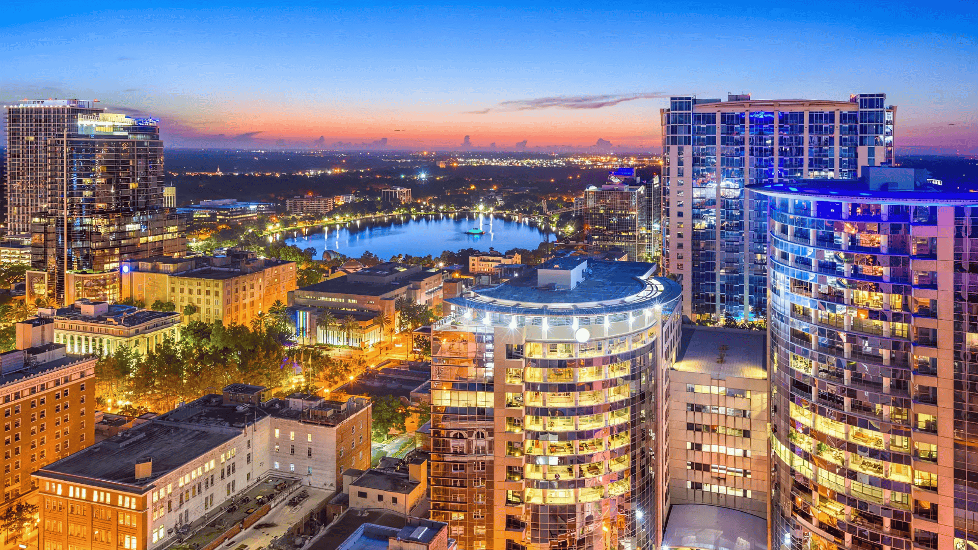 Twilight aerial view of Orlando skyline and Lake Eola, within Air Titans’s service region