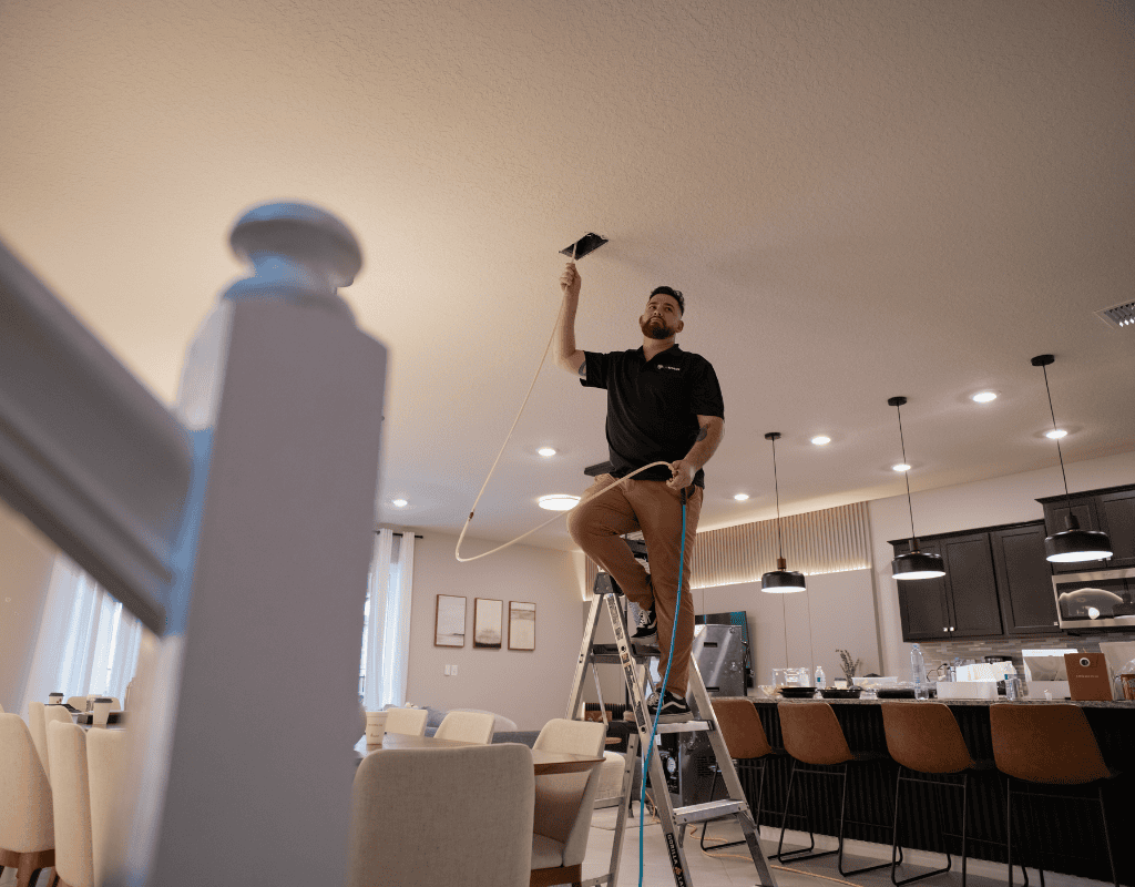 Air Titans professional using specialized equipment to seal indoor ductwork in a Tampa residence