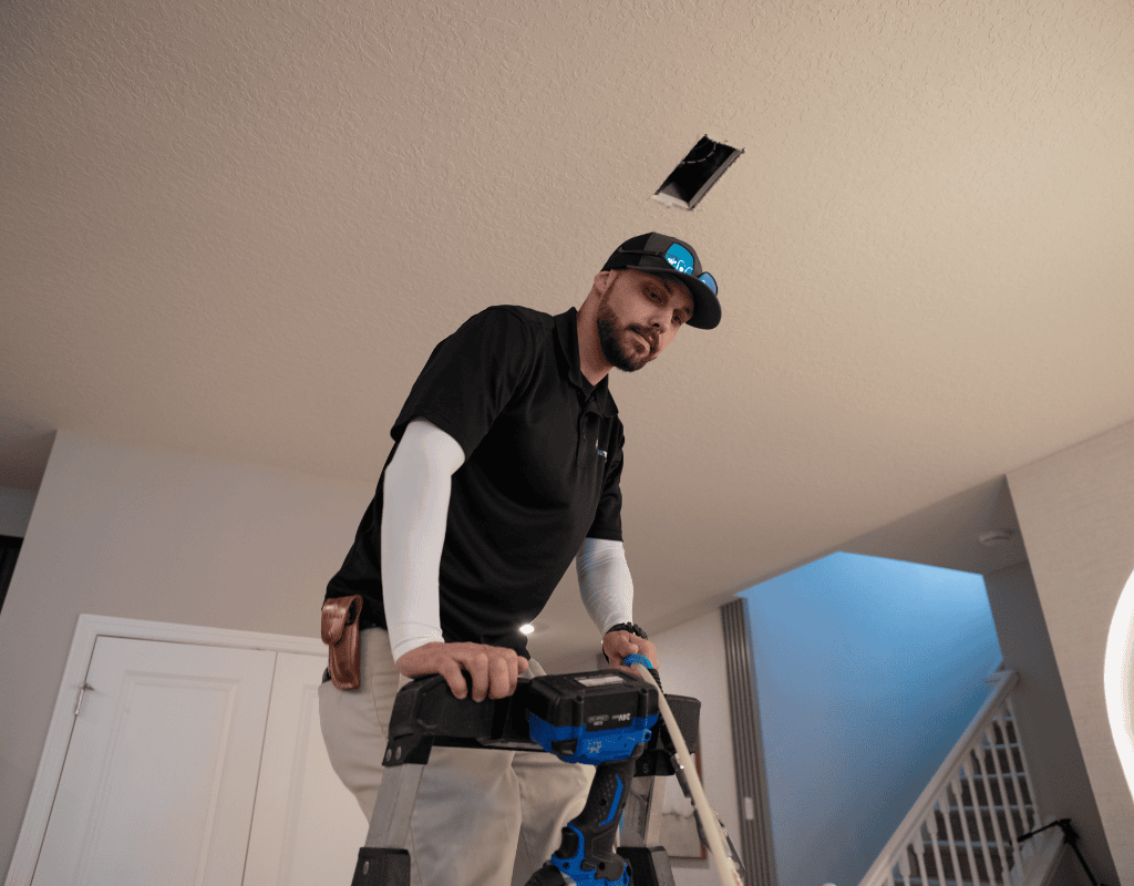 Air Titans professional working on indoor duct system in a Clearwater, FL home