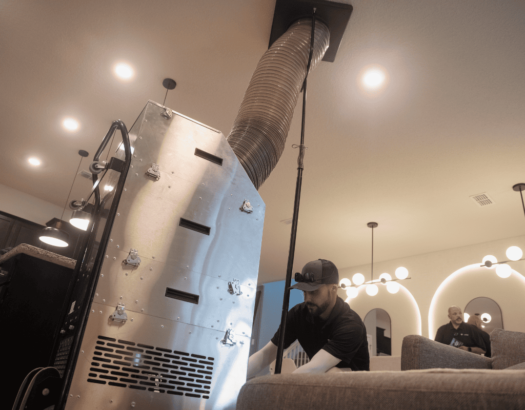 Air Titans technician using specialized equipment for HVAC maintenance at a Tampa residence
