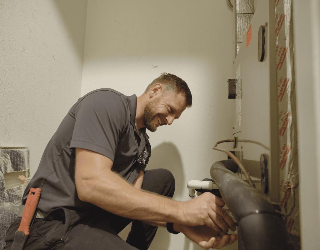 Air Titans technician performing HVAC repair on an indoor unit in a Tampa home
