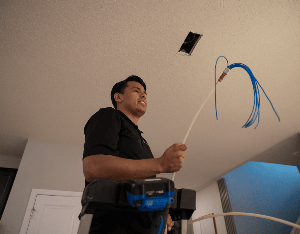 Air Titans technician preparing UV light installation to improve air quality in Tampa