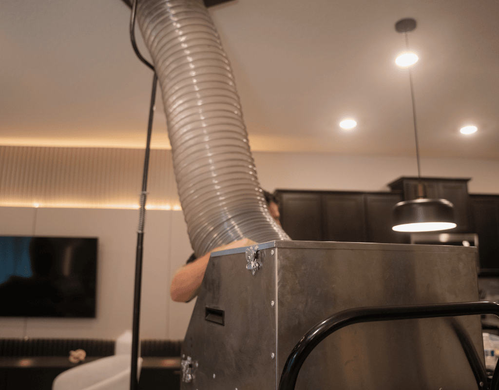 Air Titans technician setting up duct cleaning equipment inside a St. Petersburg, FL home