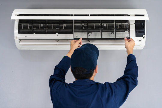 Air Titans technician servicing Tampa air conditioning unit