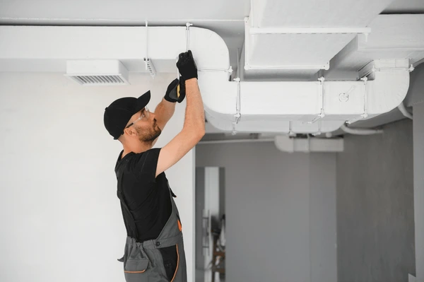 Professional technician fixing air ducts in Tampa FL