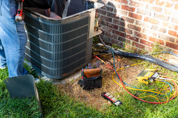 HVAC expert repairing outdoor AC system in Brandon FL home