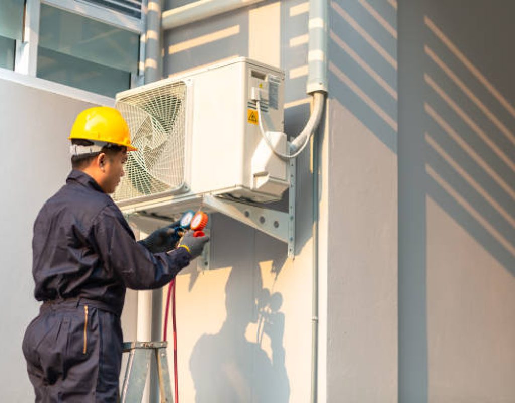 Expert cooling technician servicing air conditioner in New Tampa, FL